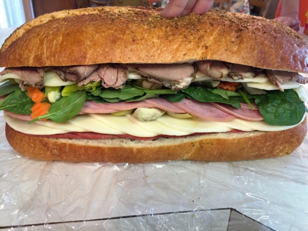 5.	When you have all the layers on your sandwich, top with the other half of the bread to close into the sandwich,