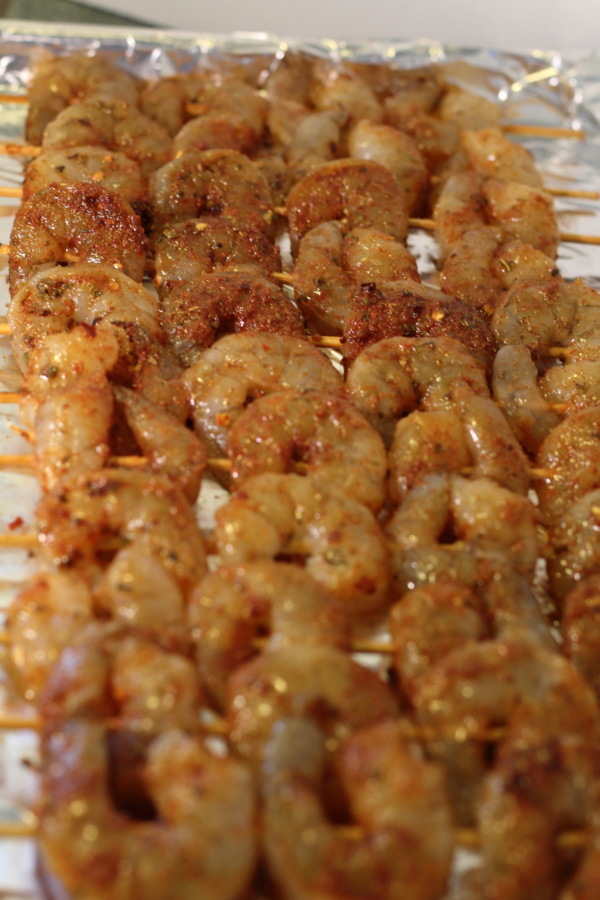 Using 2 bamboo or metal skewers poke through the top and bottom of the shrimp and push down to the bottom of the skewer. Continue to add to the skewer, 4 shrimp per skewer, so they have room and cook evenly. 